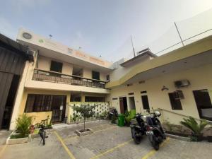 a motorcycle parked in a parking lot in front of a building at OYO 93274 Oren Home Bekasi in Bekasi