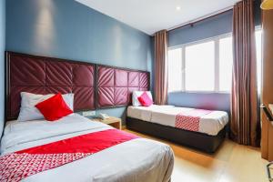 Postel nebo postele na pokoji v ubytování OYO 90894 Hotel Smc I-city