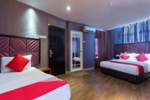 Postel nebo postele na pokoji v ubytování OYO 90894 Hotel Smc I-city