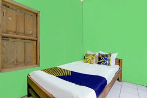Ένα ή περισσότερα κρεβάτια σε δωμάτιο στο Hotel O Hadi Homestay Syariah
