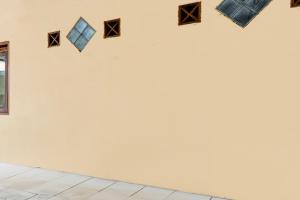 a white wall with different colored squares on it at OYO Life 93398 Sudimoro Guest House Syariah in Blimbing +22 photos