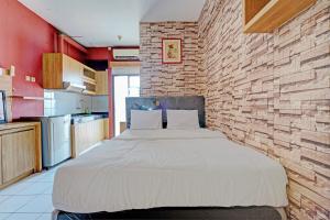 Ένα ή περισσότερα κρεβάτια σε δωμάτιο στο OYO 93352 Apartement Gateway Cicadas By Db Rent