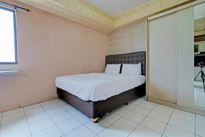 Ένα ή περισσότερα κρεβάτια σε δωμάτιο στο OYO 93352 Apartement Gateway Cicadas By Db Rent