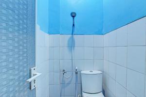 a bathroom with a shower with a toilet in it at Capital O 93361 Dynasty Inn Syariah in Pekalongan +22 photos