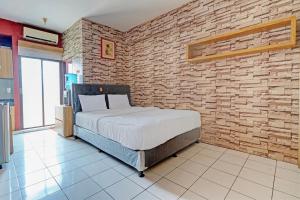 Ένα ή περισσότερα κρεβάτια σε δωμάτιο στο OYO 93352 Apartement Gateway Cicadas By Db Rent