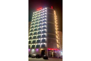 a building with a hotel sign on top of it at OYO Townhouse 156 Rose Hotel Apartments in Muscat
