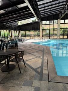 a large swimming pool with a table and chairs at Dream Flat Pinheiros in São Paulo
