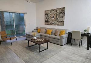 a living room with a couch and a table at Orlando Family Getaway Near Walt Disney World in Kissimmee