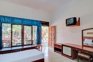 Postel nebo postele na pokoji v ubytování Capital O 93236 Hotel Hapel Negara + 31 fotografií