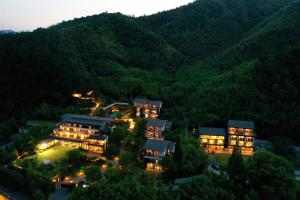 an aerial view of a resort in the mountains at night at 莫干山缦田生态度假酒店 in Deqing