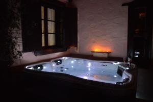 a large bath tub in a room with a window at Fimaira in Ermoupoli
