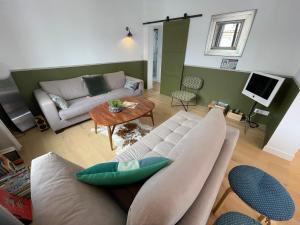 a living room with a couch and a table at Charmante villa bord de mer avec parking et WiFi, proche plage et commerces - FR-1-22-377 in La Tranche-sur-Mer