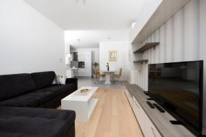 a living room with a couch and a large television at Luxury Apartment "Ema", sea view in Split
