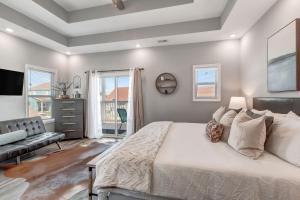 a bedroom with a large bed and a couch at The Modern Mainstay at Barefoot Bay in Winchester +34 photos
