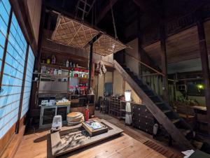 a large room with a staircase in a building at Koyado Namiji in Matsue