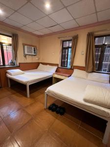 Ένα ή περισσότερα κρεβάτια σε δωμάτιο στο HK Peaceful Guesthouse