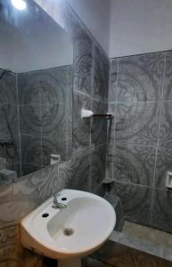 a bathroom with a white sink and a mirror at Departamento in Termas de Río Hondo