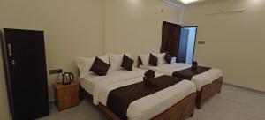 Voodi või voodid majutusasutuse Rv Resorts Yercaud toas