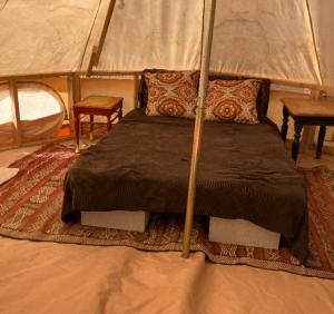 a bedroom with a bed in a tent at The Yurt at Tribal Camp in Joshua Tree