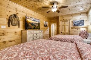 a bedroom with two beds and a ceiling fan at Serenity Brook- Pickleball Court, Creek, WIFI, Mountain Views, Starting at 99 in Cosby