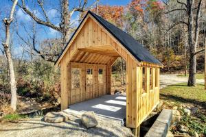 a wooden dog house with a black roof at Serenity Brook- Pickleball Court, Creek, WIFI, Mountain Views, Starting at 99 in Cosby