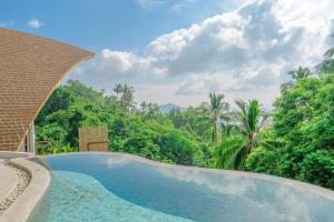 a swimming pool in the middle of a forest at Phra Chan Villa 2BR Infinity Pool & Sea View in Chaweng Noi Beach