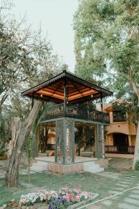 a gazebo in a park with flowers at Nidhivann- A Wellness Retreat Resort Pench in Khawāsa