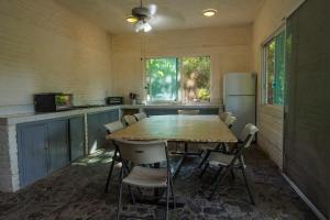 a kitchen with a table and chairs and a refrigerator at Casa Soñada a la Orilla del Rio in Conca