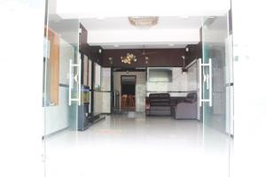 a view through a glass door into a kitchen at Kalyan Residency By Azalea in Madurai