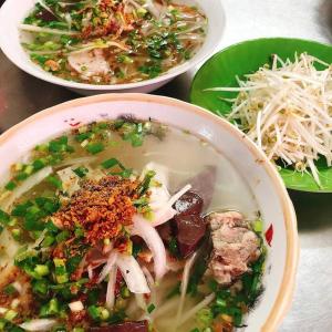 two bowls of soup and a plate of food at Nipola Hotel - Chợ Đêm Dương Đông Phú Quốc in Phú Quốc