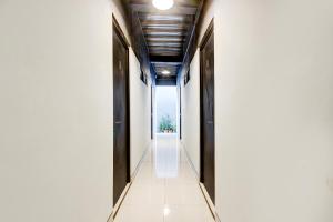 a corridor of an office building with a view of the street at Hotel O Rubina Syariah Hotel in Purbolinggo +25 photos