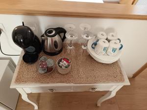 a table with cups and wine glasses on it at I Limoni di Vernazza in Vernazza