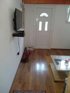 a living room with a door and a table at Apartments Popovic in Podgorica +15 photos