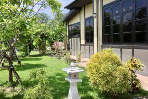 a white fire hydrant in front of a building at Morimei Khaoyai in Ban Khlong Yang