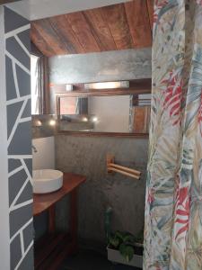 a bathroom with a sink and a mirror at Square de Vohémar in Vohemar