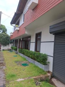 a house with a yard next to a building at Plus in Negombo