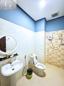a bathroom with a white toilet and a sink at Vang Vieng Misokxay Hotel in Vang Vieng