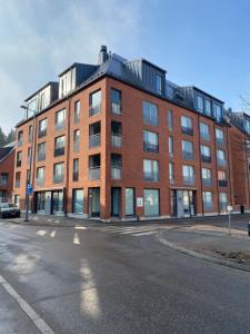 a large red brick building on a city street at Cozy apartment - Free WIFI in Espoo