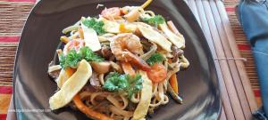 a plate of pasta with shrimp and vegetables at Square de Vohémar in Vohemar