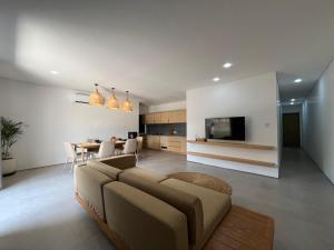 a living room with a couch and a dining room at Teras by Tamora in Badung