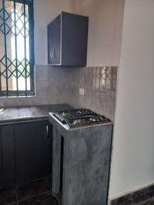 a kitchen with a stainless steel stove top oven at Exclusive-View Lodge in Akropong +4 photos