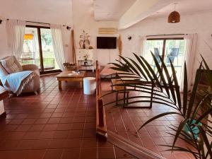 a living room with a couch and a table at Las Moras casa de campo en Lobos in Lobos