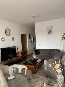 a living room with a couch and a tv at Luxurious Apt with Rooftop Pool in Dakar