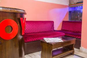 a red bench in a room with a table at OYO 810 Hotel Peace Golden in Kathmandu