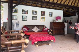 a living room with a couch and a table at Belvilla Pleasant Seaside Lovina Beach in Lovina