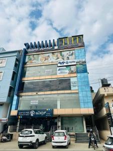 a building with cars parked in front of it at Mystay suites in Bengaluru