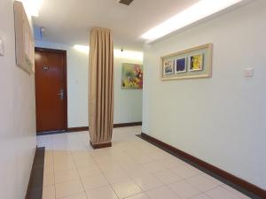 an empty hallway with a door and a curtain at Capital O 90939 Sandakan Central Hotel in Sandakan +33 photos