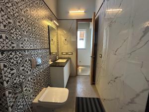 a bathroom with a sink and a toilet in it at VAAS Cottage in Mukteshwar