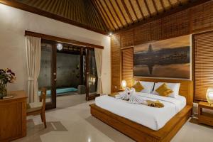 a bedroom with a large bed and a window at Belvilla Prakriti Near Monkey ForestNearCampuhan Ridge Walk in Ubud