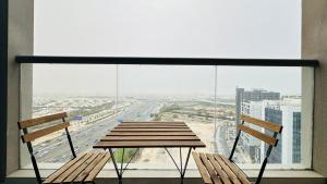 a table and two chairs in front of a window at Luxury Studio Apartments Business Bay With Balcony and Free parking by Belvilla in Dubai